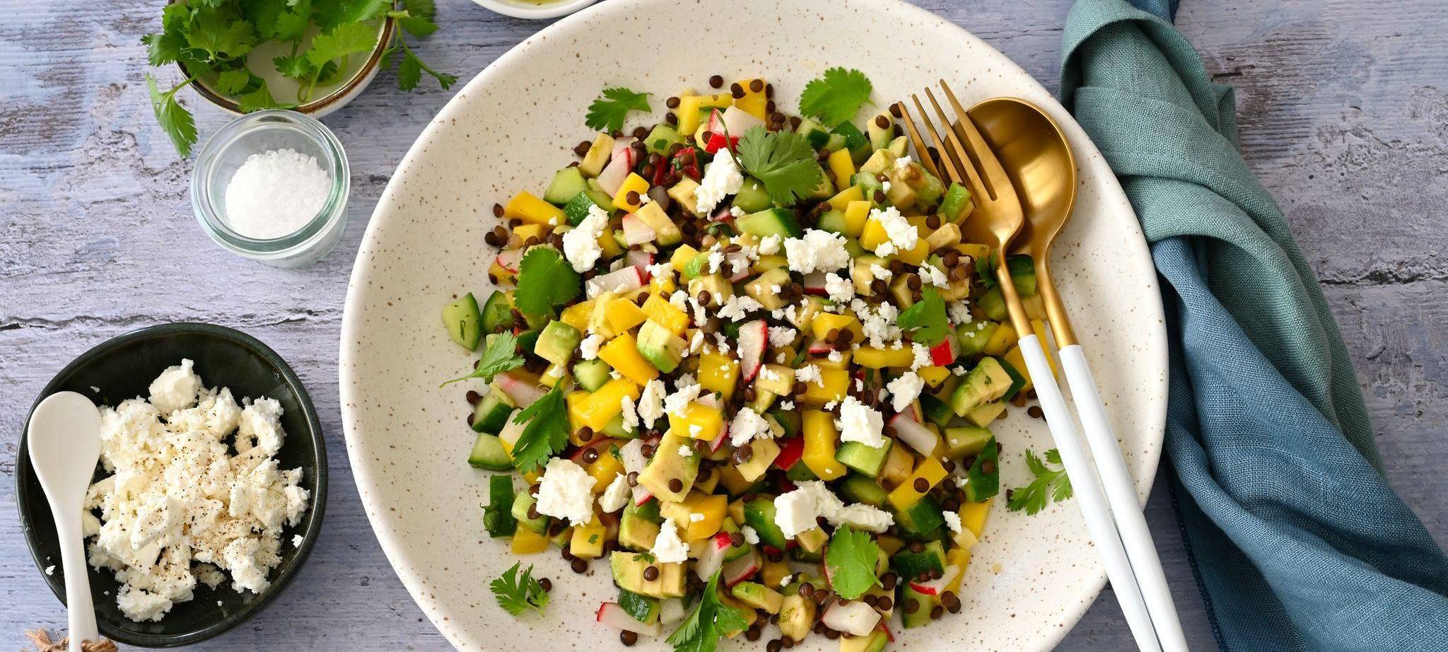 Ein Teller mit Linsensalat und weiteren Zutaten