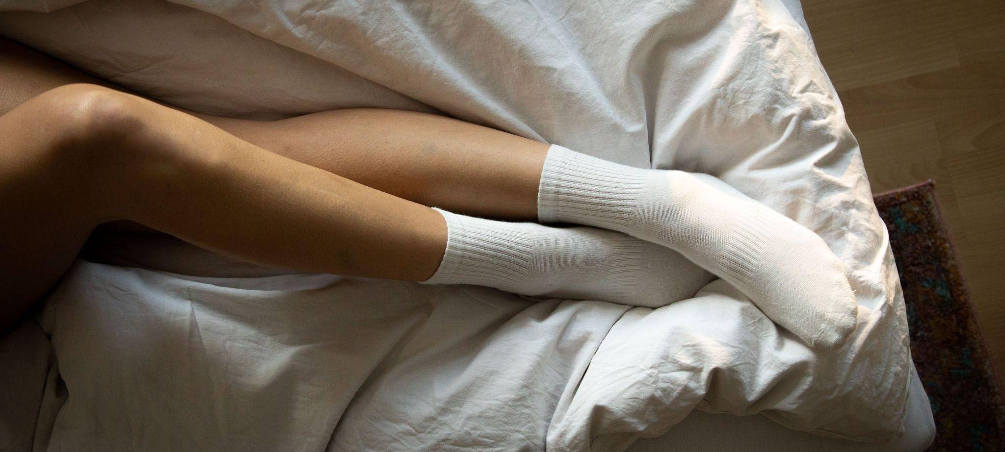 Die Beine einer Frau im Bett